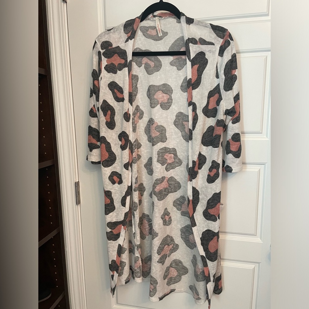 Lightweight womens cardigan with pockets. Semi-sheer with modern abstract print.